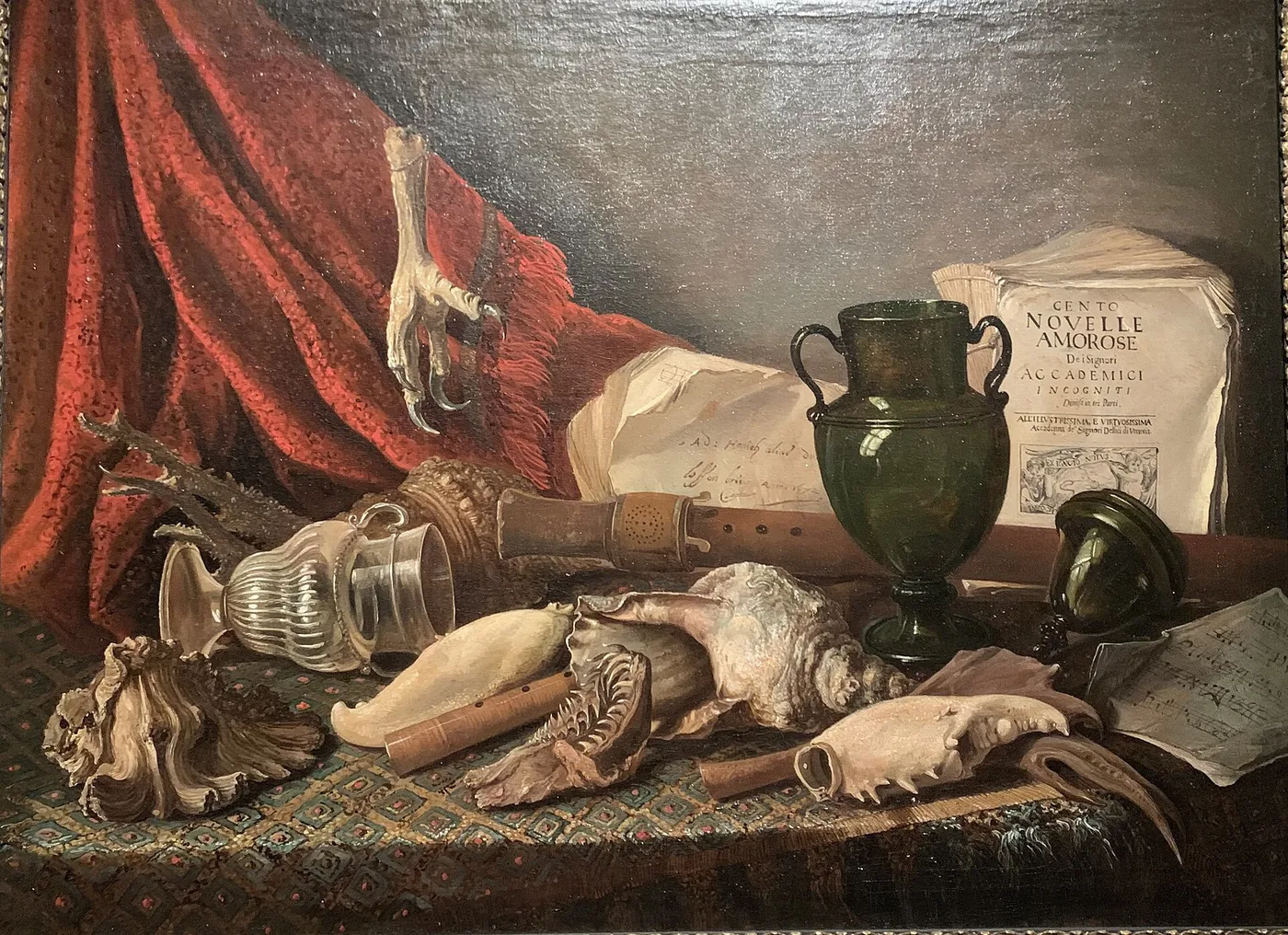 Still life on a draped table with music instruments, musical scores, a lying vase, a large shell, and the claw of a bird of prey, 1672 (1672) by Adriaen Honich — original painting reproduced as a hand-painted oil on canvas